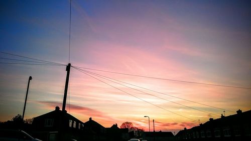 Low angle view of silhouette building against sky