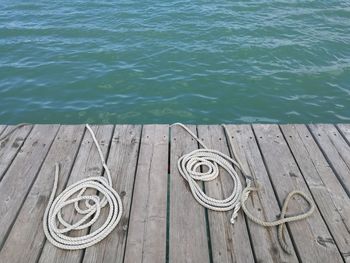 High angle view of ropes on pier over sea