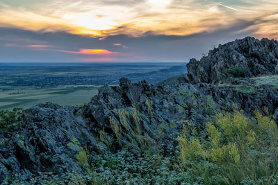 Scenic view of rock formation against sky during sunset