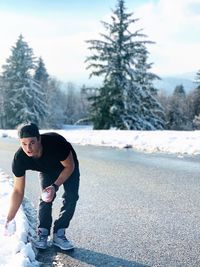 Full length of young man standing on road in winter