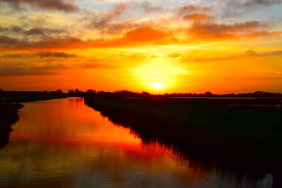 Scenic view of lake against romantic sky at sunset