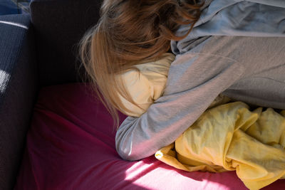 High angle view of woman sleeping on bed at home