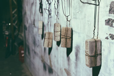 Close-up of metal hanging against wall