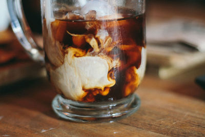 Close-up of iced coffee in glass on table