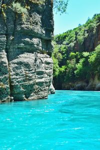 Scenic view of sea against rock formation