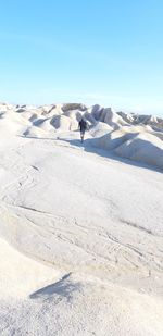 Scenic view of white desert landscape against sky