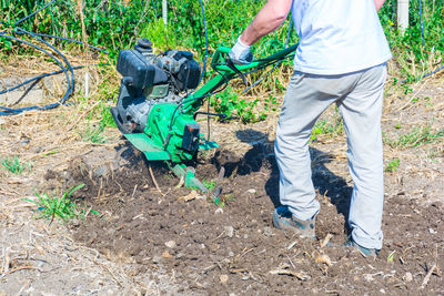 Low section of man working on field