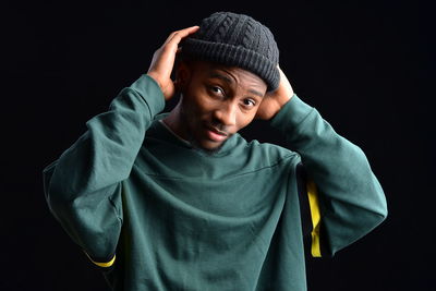 Portrait of boy against black background