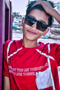 Portrait of young man wearing sunglasses standing outdoors