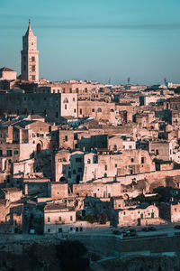 Buildings in city against clear sky