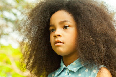 Close-up of thoughtful girl with curly hair
