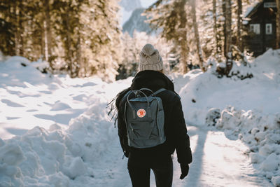 Rear view of man in snow covered landscape