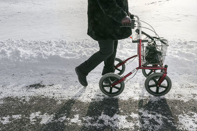 Senior with walking frame having walk at winter