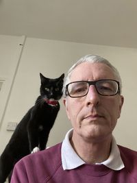 Portrait of man with cat