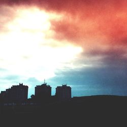 Low angle view of buildings against cloudy sky