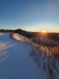 Scenic view of snowcapped mountains against sky during sunset