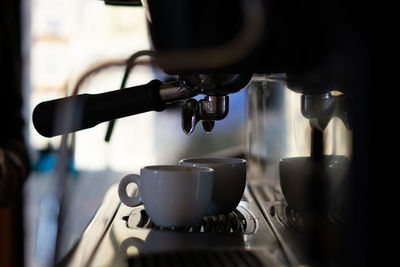 Close-up of coffee cup on the italian machine 