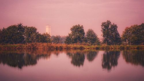 Scenic view of lake against sky at sunset