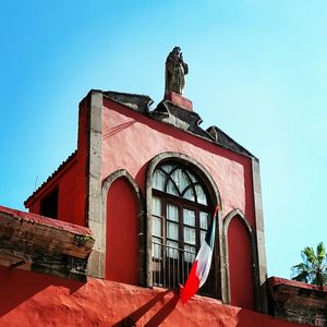 Low angle view of built structure against clear blue sky