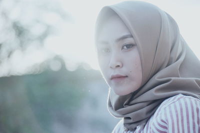 Side view of woman wearing hijab during sunset