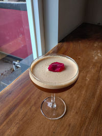 High angle view of red wine in glass on table