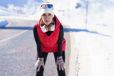 Portrait of young woman walking on snow