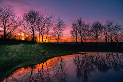 Scenic view of lake against romantic sky at sunset