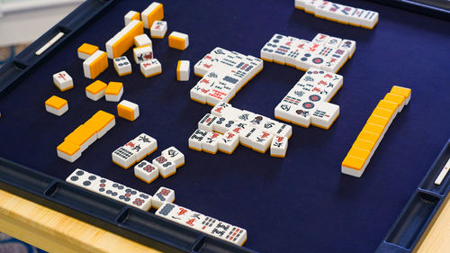Many mahjong tiles on on the playing field. an ancient asian game called mahjong. 