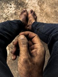 Low section of man sitting on land