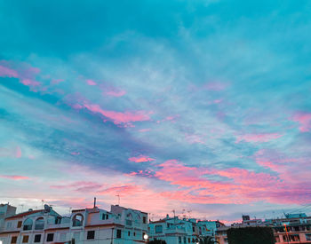 Low angle view of buildings against sky during sunset