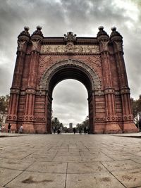 Low angle view of historical building against cloudy sky