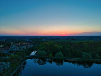 Scenic view of river against sky at sunset