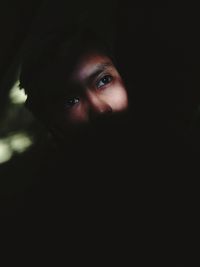 Thoughtful woman in darkroom