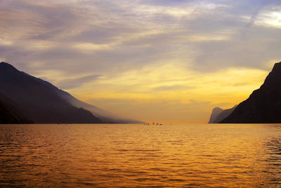 Scenic view of sea and mountains during sunset