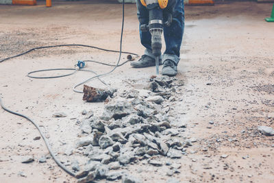 Low section of man working on ground