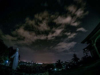 Low angle view of trees against sky at night