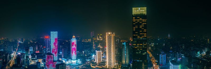 Illuminated modern buildings in city at night