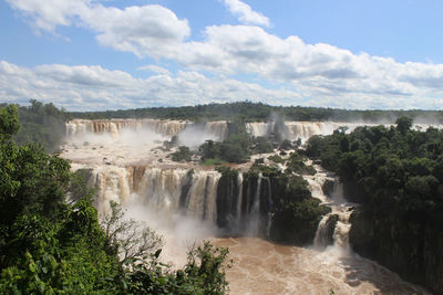 Scenic view of waterfall against sky