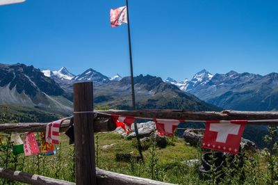 Built structures against mountain range and blue sky