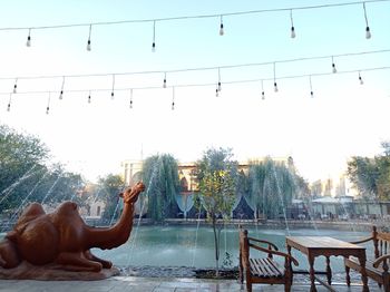 Man relaxing in swimming pool against sky