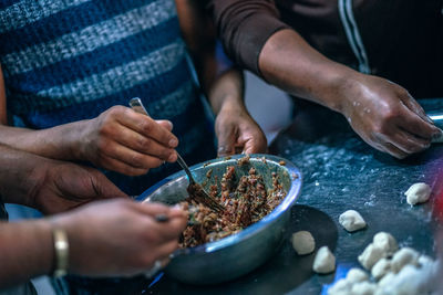 Midsection of man preparing food in kitchen