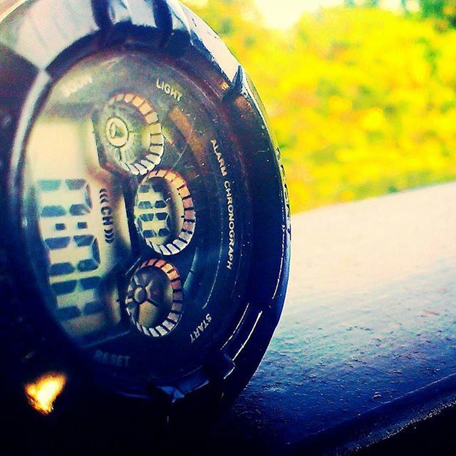 close-up, focus on foreground, indoors, communication, text, number, glass - material, old-fashioned, part of, technology, time, western script, metal, yellow, retro styled, single object, no people, circle, cropped, reflection