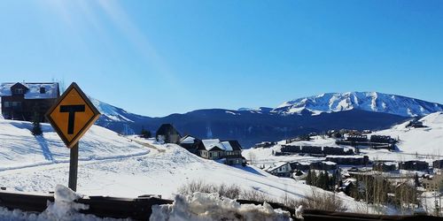 Scenic view of snow covered mountains against clear blue sky