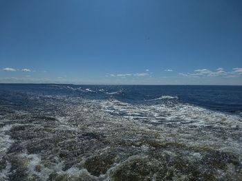 Scenic view of sea against blue sky