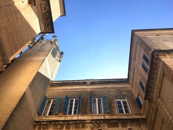 Low angle view of building against clear blue sky