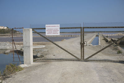 View of fence on beach against clear sky