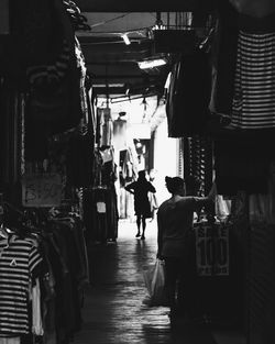 Rear view of people walking in market