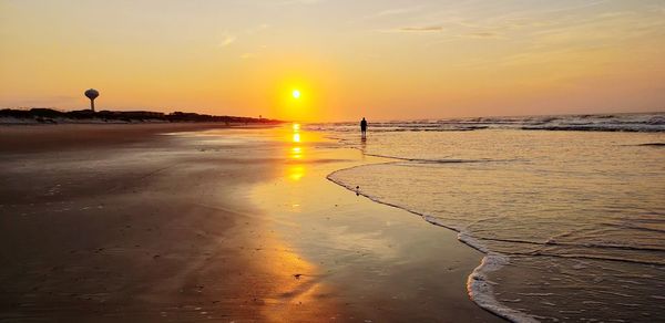 Scenic view of beach against sky during sunset