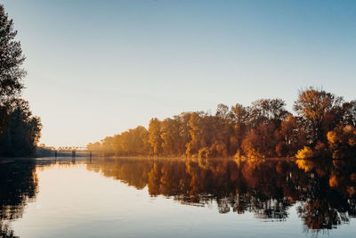 Scenic view of lake against clear sky during autumn