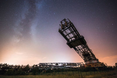 Low angle view of tower against sky at night